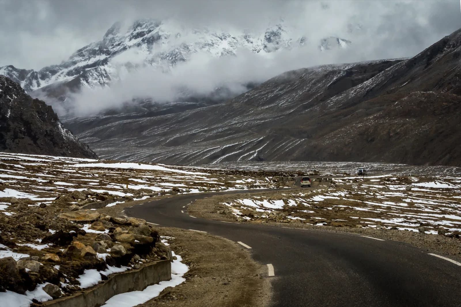 Winding road with patches of snow near Lachen