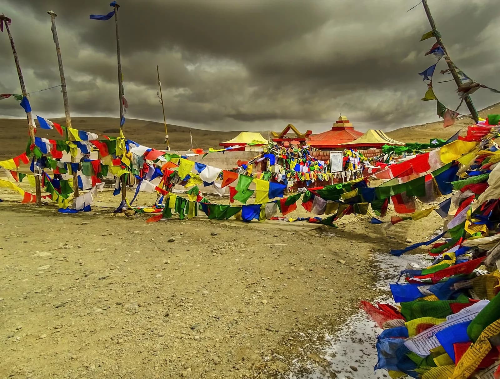 Prayer flags and a small shrine at Gurudongmar Lake